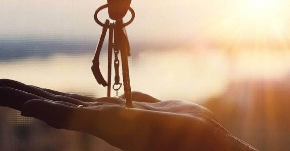 Photo of someone placing keys in someone else's hand.